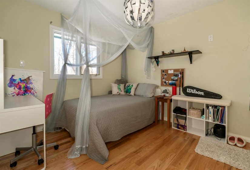 One of three bedrooms on the main with wood floors.