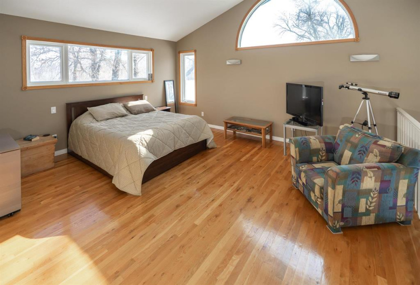 Primary bedroom with windows on three walls