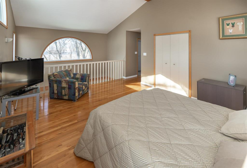 Primary bedroom showing loft rail and walk-in closet