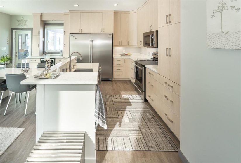 The kitchen area of the great room with high end appliances