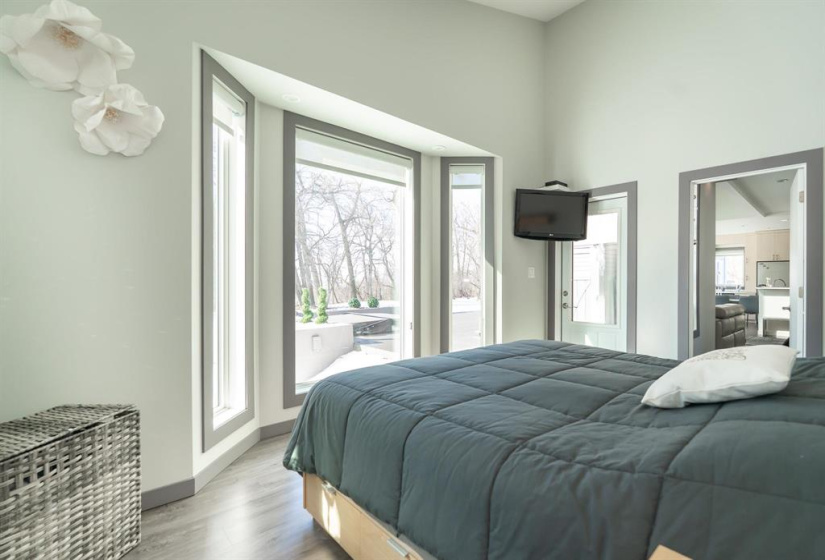 Primary bedroom on the main floor with direct access to the deck