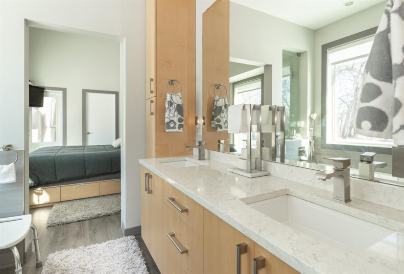 Showing the look through to the primary and the double sinks in the vanity