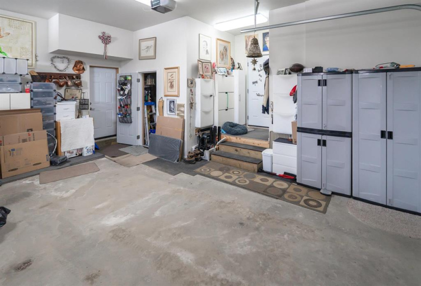 Lots of storage with dual overhead doors, man door to the yard and workshop/storage room.