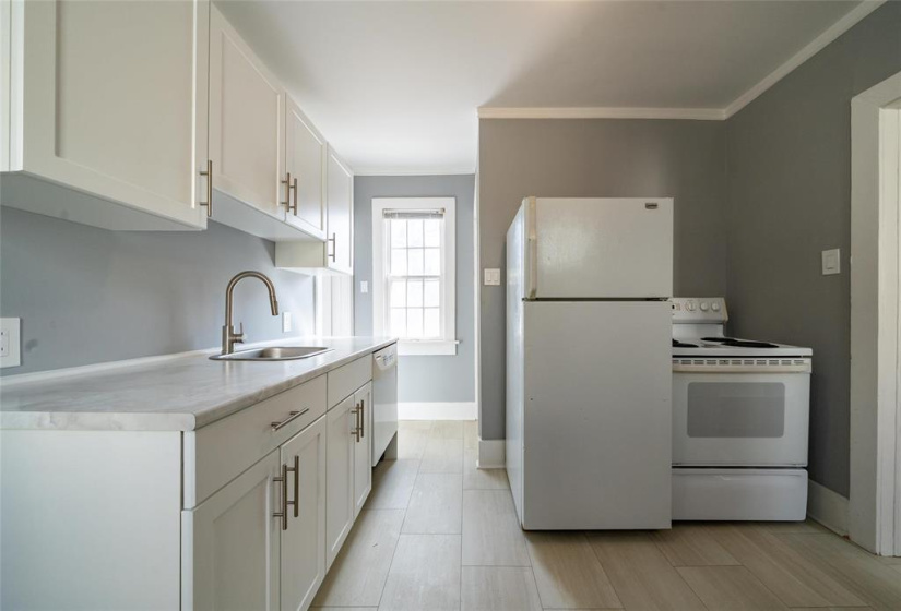 Updated kitchen, including vinyl plank flooring.