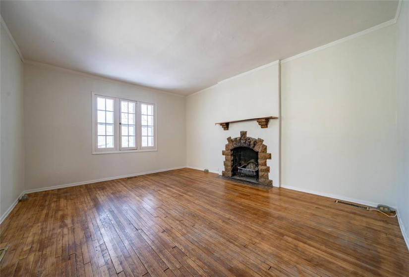 Bright, spacious living room with ornamental fireplace.