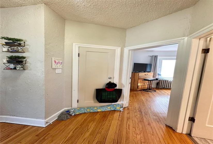 main floor hallway with second floor stairwell behind closed door
