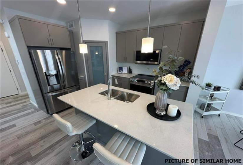 Island Kit with breakfast bar and corner walk-in Pantry.