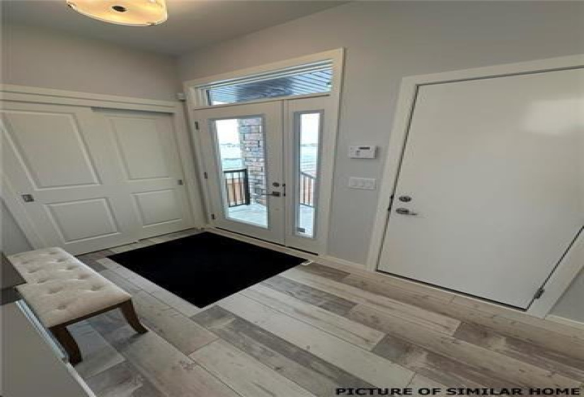 Entrance foyer with sliding double clothes closet. Inside door to the garage on the Left.