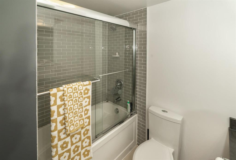 Remodeled bathroom with tiled surround