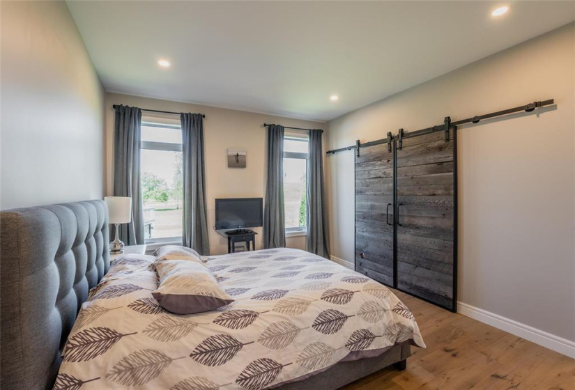 Primary suite with reclaimed barn doors to the walk-in closet