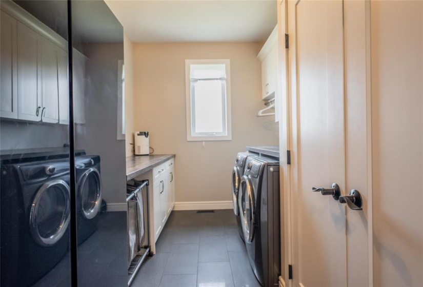 Main floor laundry with fridge/freezer