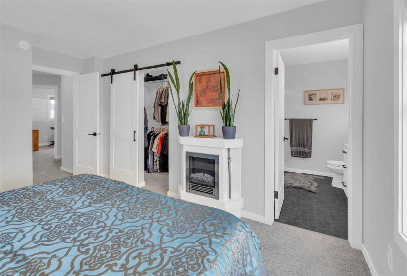 Primary w/walk-in closet with barn door.