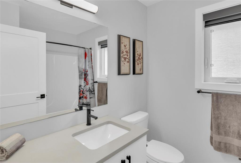 2nd floor Main 4 pce bath with window. Quartz/Caesarstone counter with undermount sink.