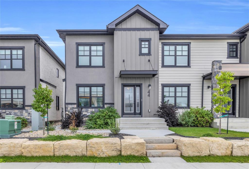 Classy front elevation with great curb appeal! Fiberglass front door & sidelight. All Tripane windows!