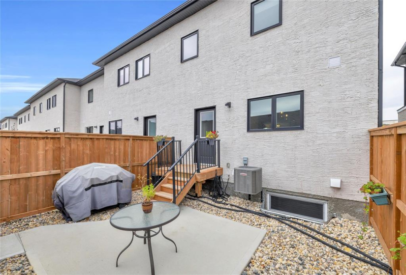 Fenced back yard with concrete patio & maintenance free landscaping. Cent A/C unit.