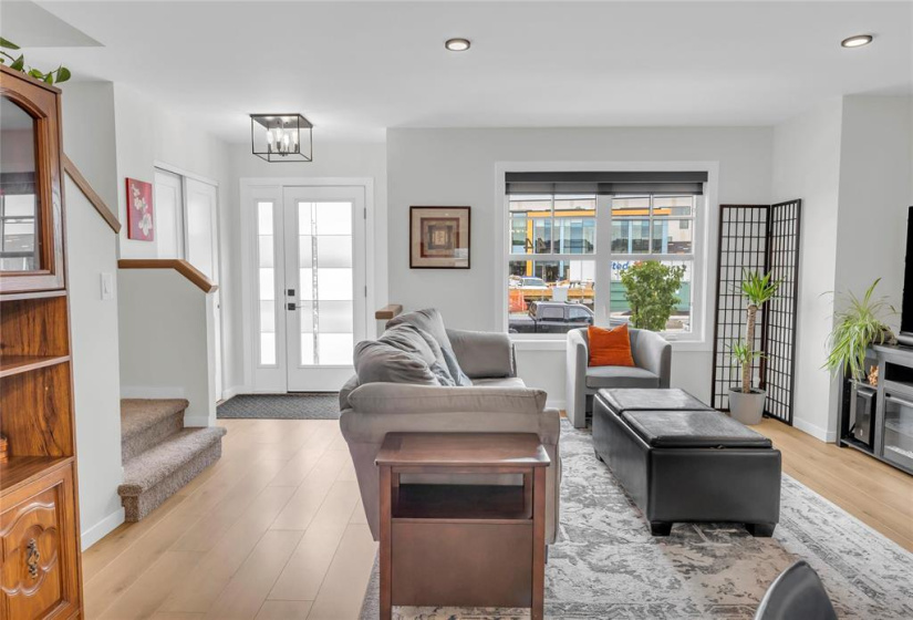 Living room with pot lights & laminate flooring.