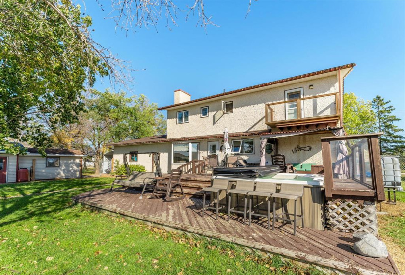 Two tier deck with 8 person hot tub. Balcony above from the primary bedroom