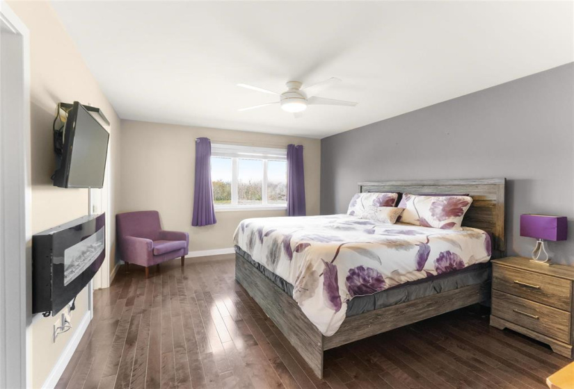 Spacious primary bedroom. Electric fireplace included. Great views out back