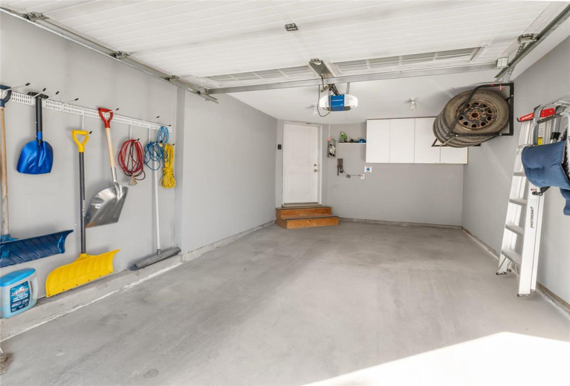 Insulated garage. EV charger, tire rack and cabinets included. Garage door opener replaced with a more quieter unit.