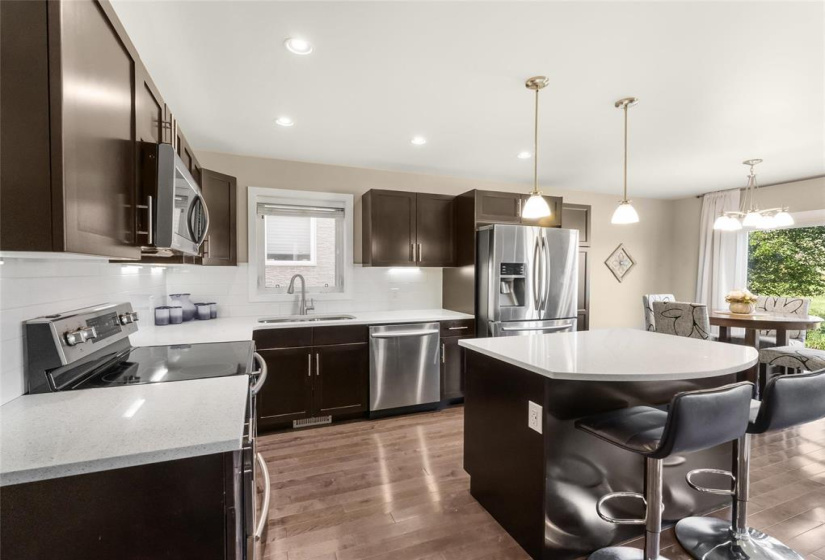 Quartz counters, classic white tiled backsplash. Higher end appliances.