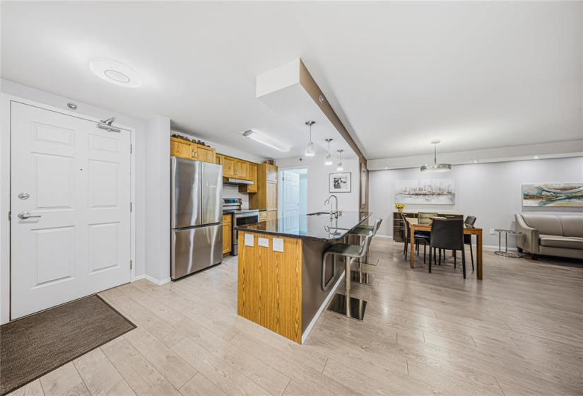 Kitchen was opened up with a large granite counter put in.  High end laminate flooring. Stipple removed from ceiling