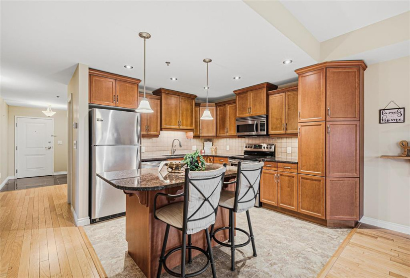 Kitchen with maple cabinets. Lots of cupboard space. Island with breakfast bar. Granite counters