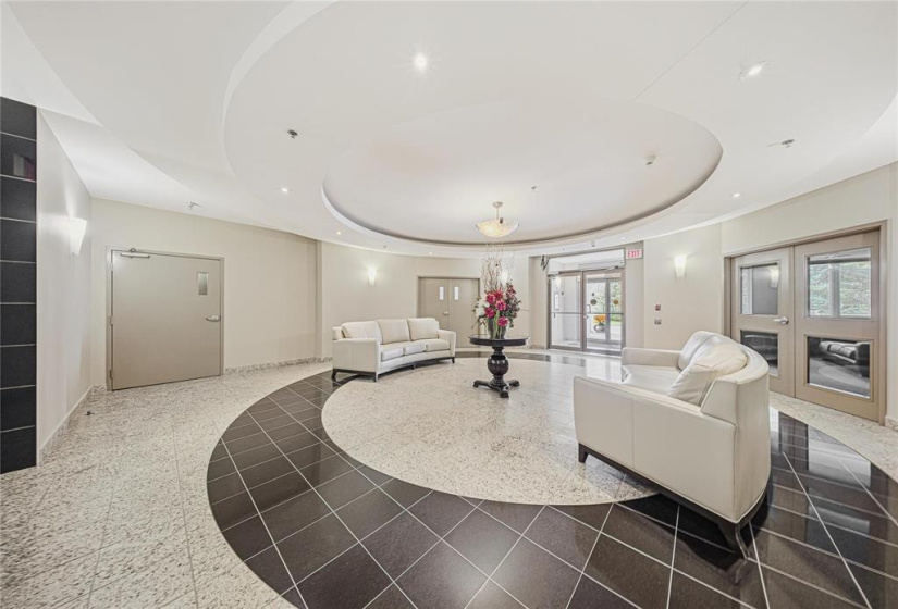 Inviting front foyer. To the left of entrance is the gym. To the right is the library, meeting/gathering or party room complete with kitchen and washroom.