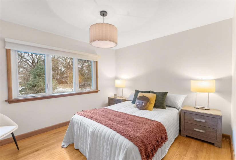 Primary bedroom. Original hardwoods, new light, paint and windows.