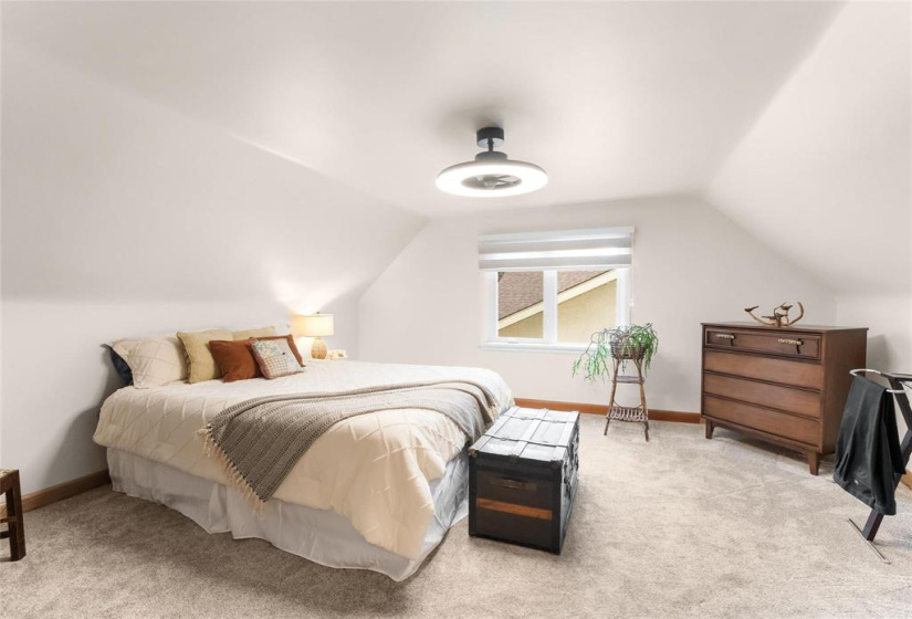 Upstairs bedroom. There is storage in the knee walls behind the bed opposite side of wall.  New carpet, light/fan, window, blinds and paint.