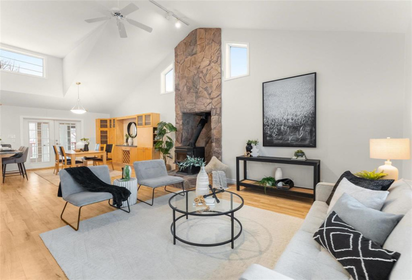 Living room open to dining room with centre wood stove.  So cozy, warming and relaxing
