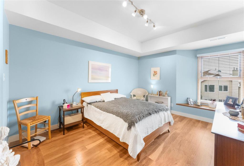 Large primary bedroom with bay window.
