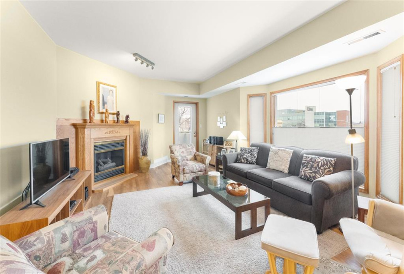 Spacious living room with garden door to balcony.  Bay window. Gas fireplace but currently not working and the board is looking into it.