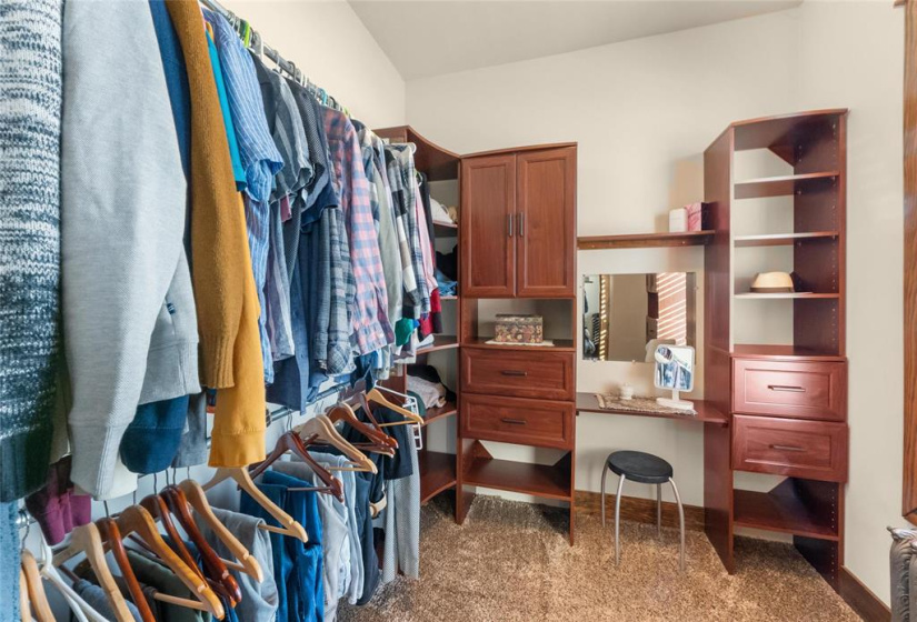 Primary bedroom walk-in closet with dressing area