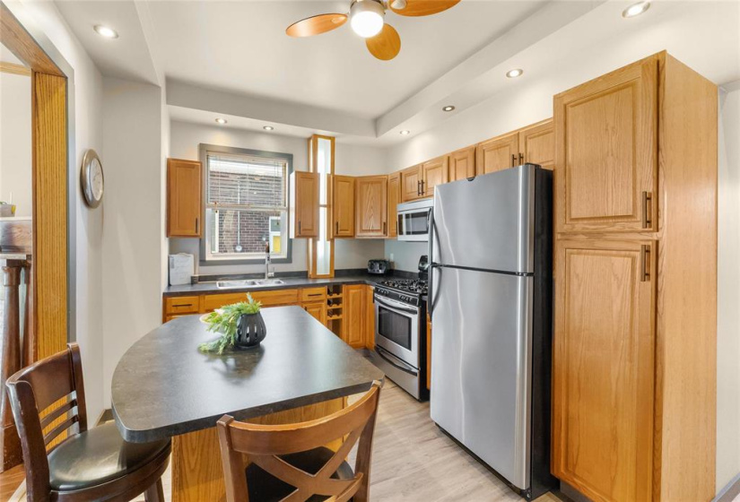 Updated kitchen with stainless steel appliances, gas stove. wine rack, pantry, island