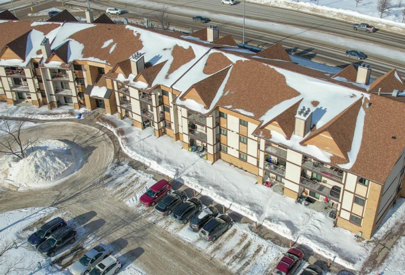 Included outdoor parking stall is beside front entrance.