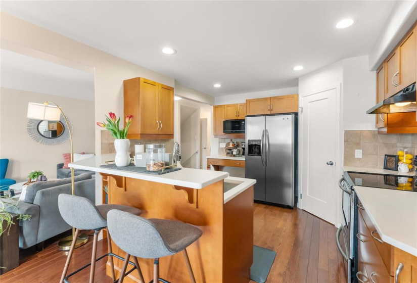 Spacious kitchen with maple cabinets, quartz counters (Sept 2025), corner pantry and stainless steel appliances.