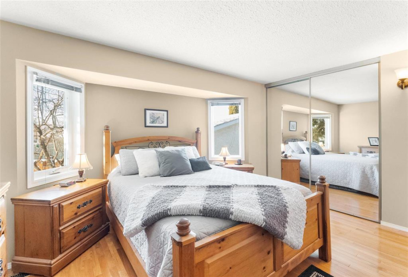 Primary bedroom with mirrored doors on closet