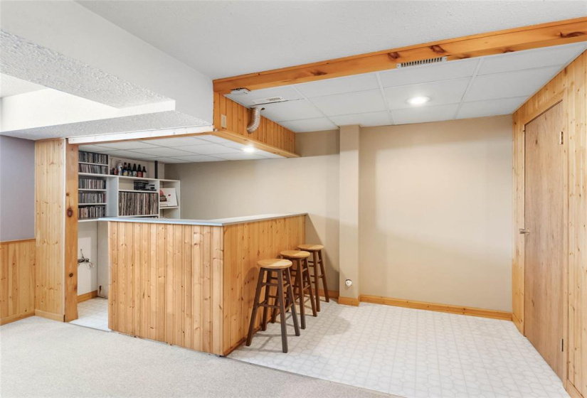 Dry bar area and door to great storage under the stairs