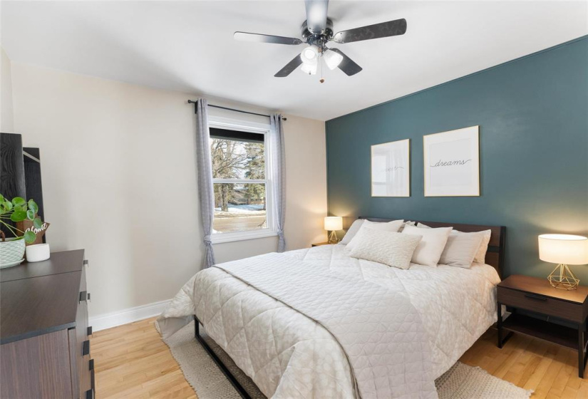 Primary bedroom. On the outside of the window is a privacy blind to keep out the light.