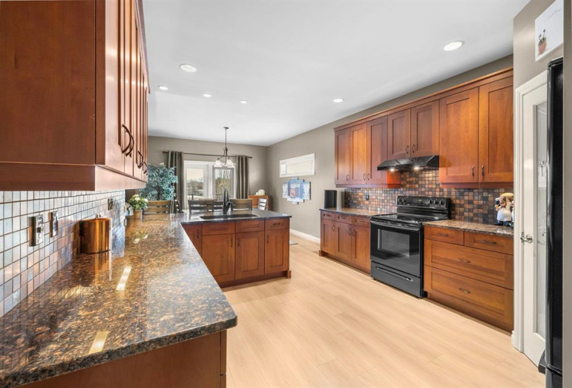 Kitchen with beautiful granite countertops and tile backsplash