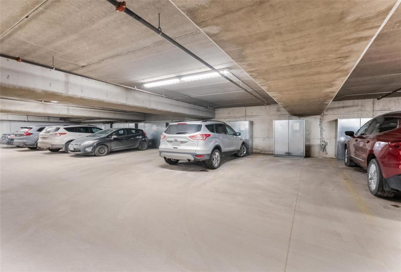 Underground parking with steel storage unit in front of the spot