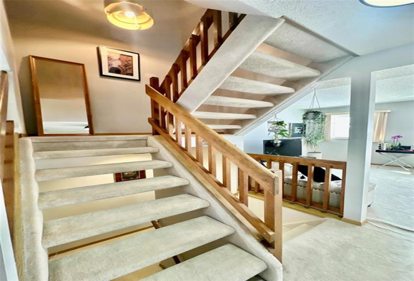 Open concept staircase to upper and lower levels