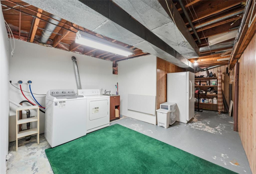 Laundry room leading to storage area.