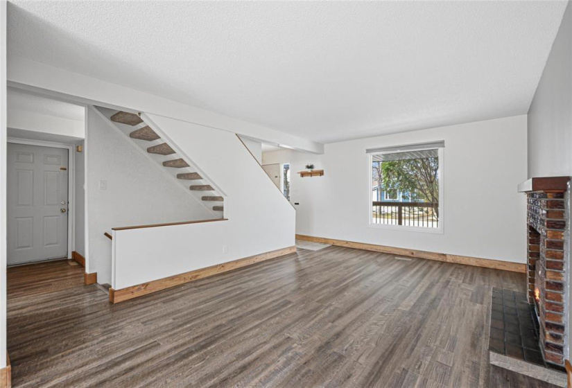 Living room with picture window overlooking front    deck
