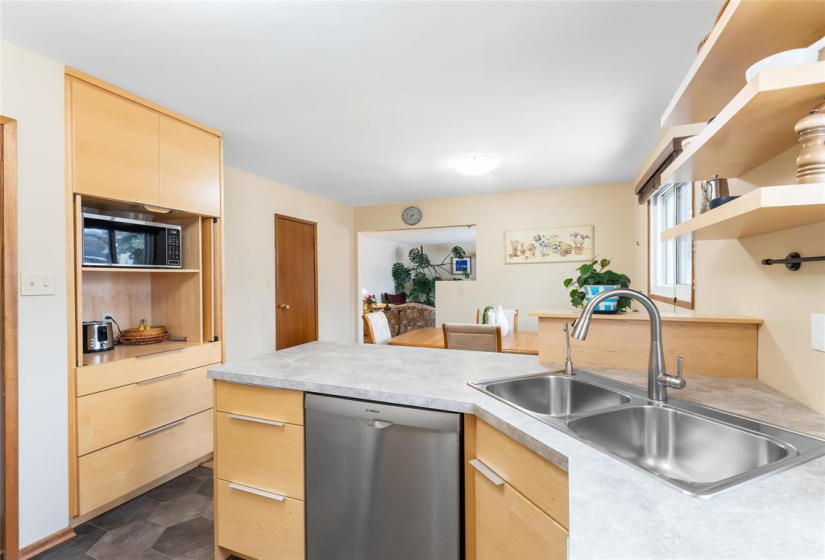 Fridge, stove, dishwasher, hood fan included.  Great little microwave / coffee nook.  Doors can be closed for a more stream lined look.