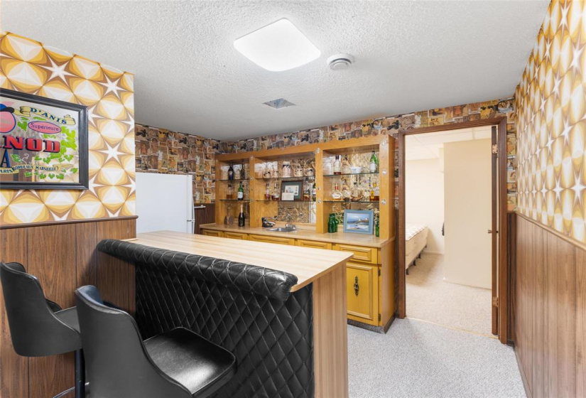 Wet bar.  Through the door is another bedroom.