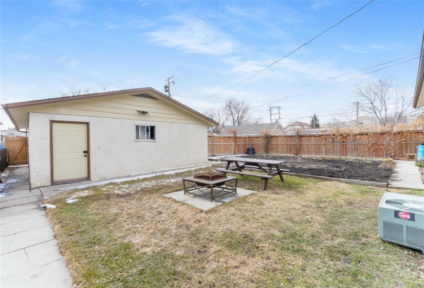 Mostly fenced back yard with large garden and oversized double detached insulated garage