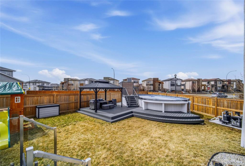 Professionally landscaped with low-maintenance composite deck with glass railing, play structure and shed