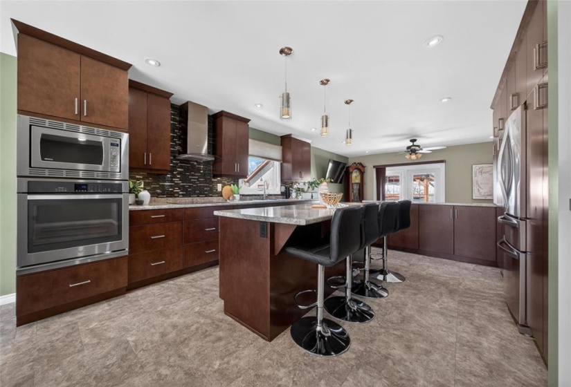 Modern kitchen with stainless steel appliances - built-in oven, cooktop & microwave.