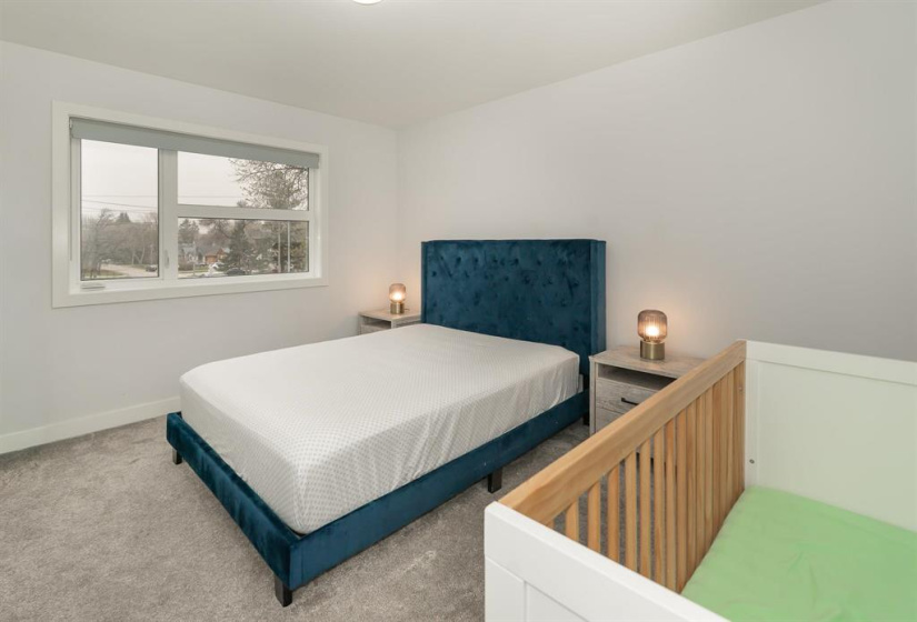 Roomy primary bedroom easily fits a king bed suie